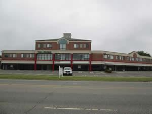Commercial property inspected — brick school building with parking lot 1